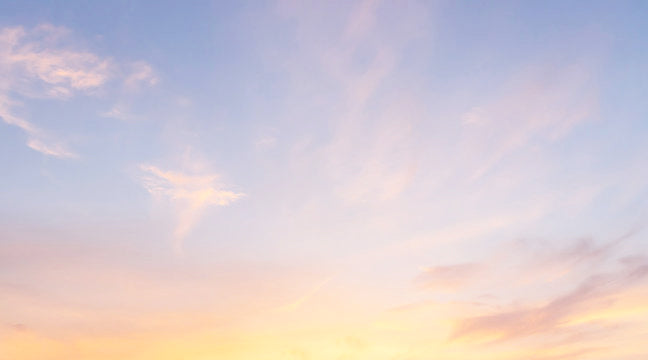 Sunrise at golden hour, clear sky, wispy clouds