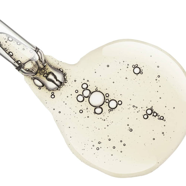 Drop of facial serum at end of bottle dropper