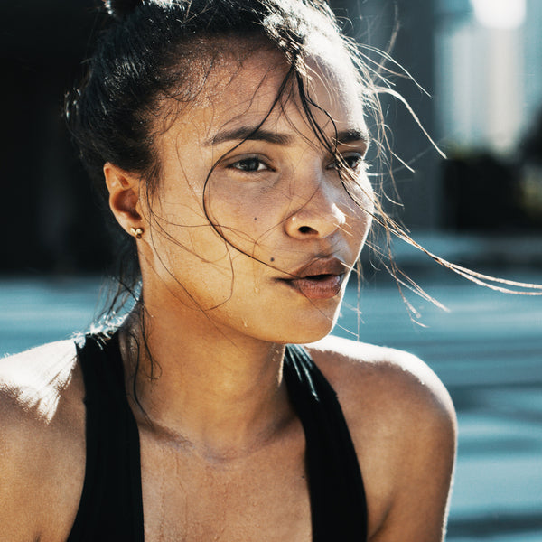 Young woman workout gear sweating exercise