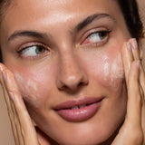 SIx Gldn model using the Botanical Cleansing Gel on both cheeks bringing it to a foamy lather 