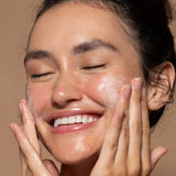 SIx Gldn model using the Botanical Cleansing Gel on both cheeks bringing it to a foamy lather 